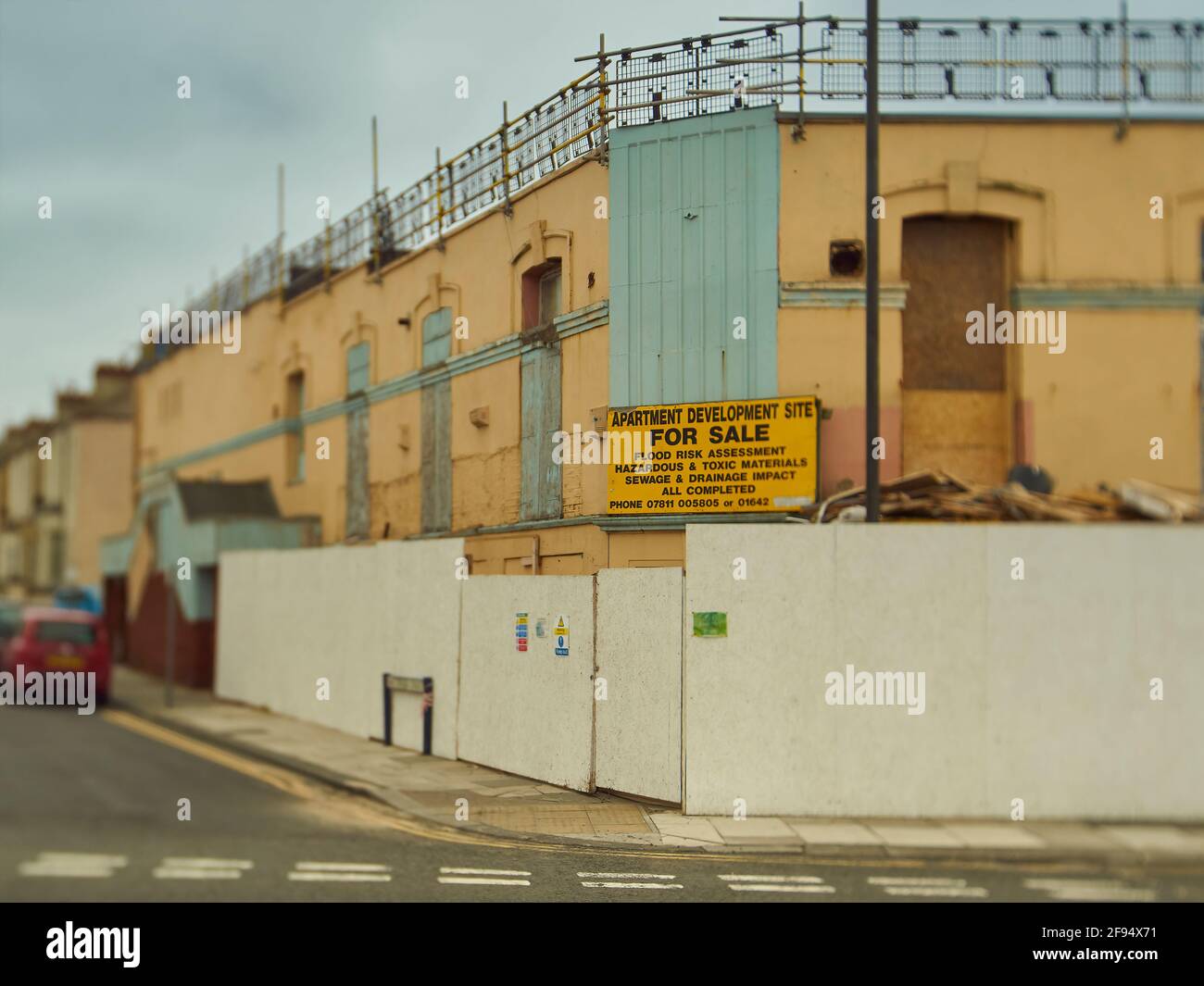 Redcar UK, Jun 2019 - A former night club, derelict and gutted, with a sign telling of future aspirations and hinting at the industrial past. Stock Photo