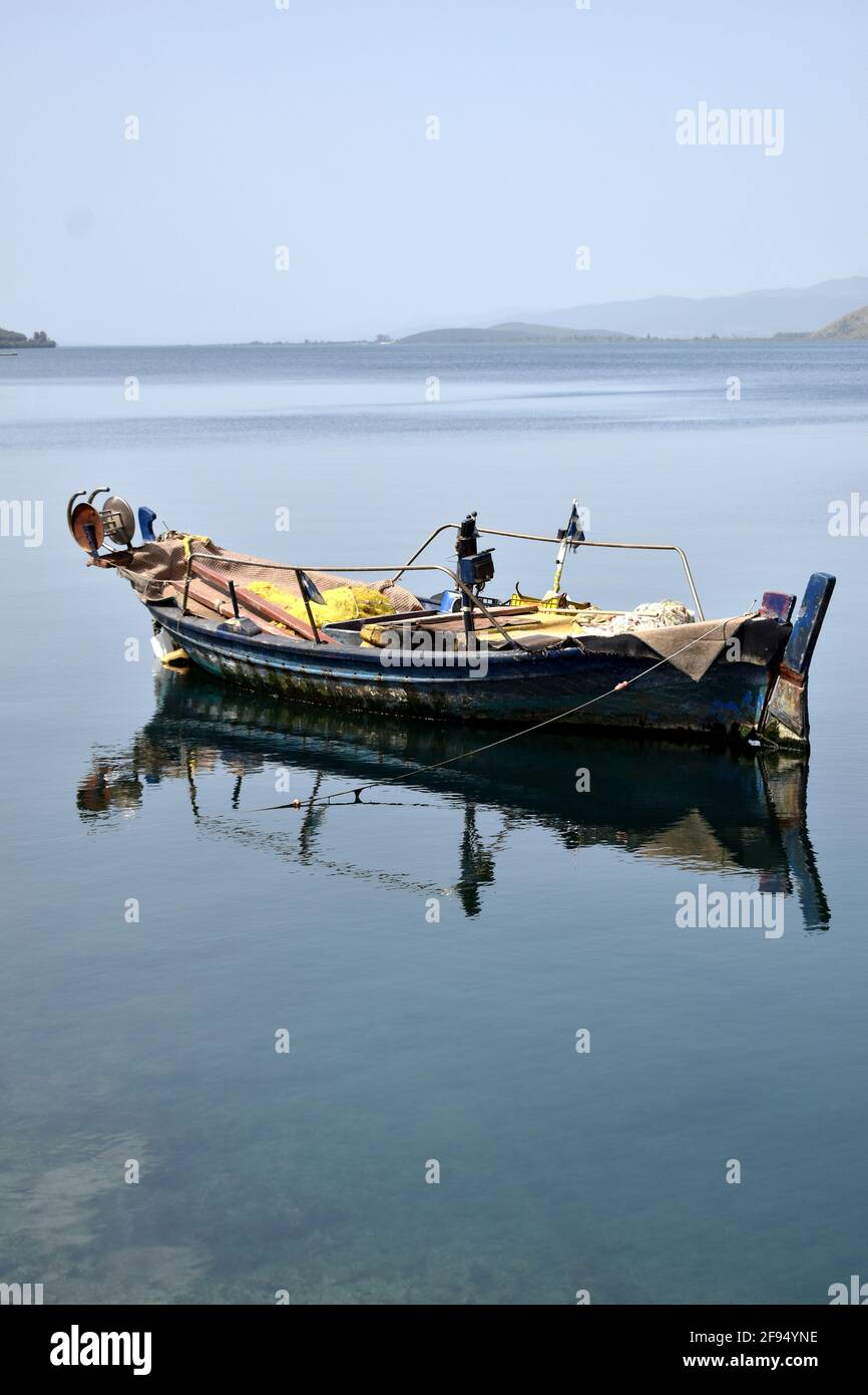 fishing boat with reflection on the water Stock Photo