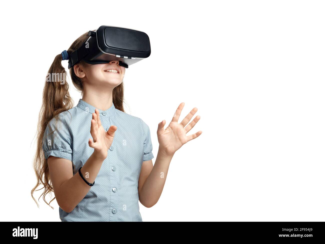 Young girl with virtual reality glasses.  Isolated on white background.  VR headset. Stock Photo