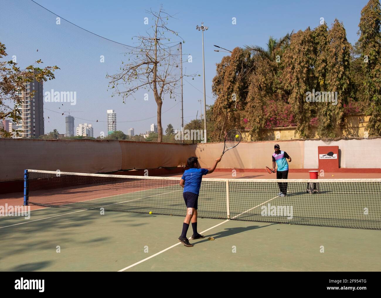 Young boy having tennis lesson with a coach at the SPG (Shivaji Park  Gymkhana) Tennis Academy in Mumbai,Maharashtra, India. Stock Photo