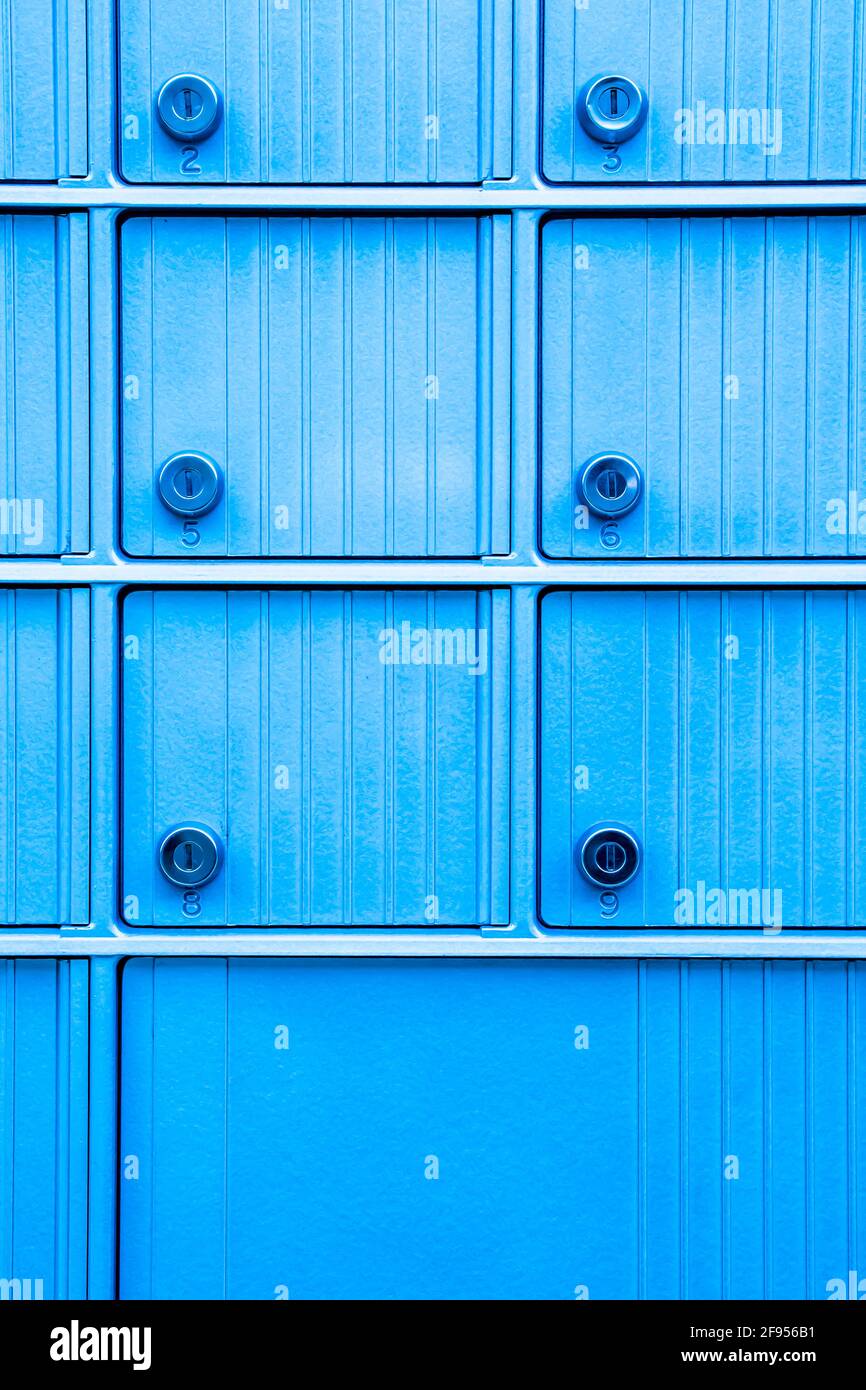 Close up of turquoise blue metal numbered mail slots Stock Photo