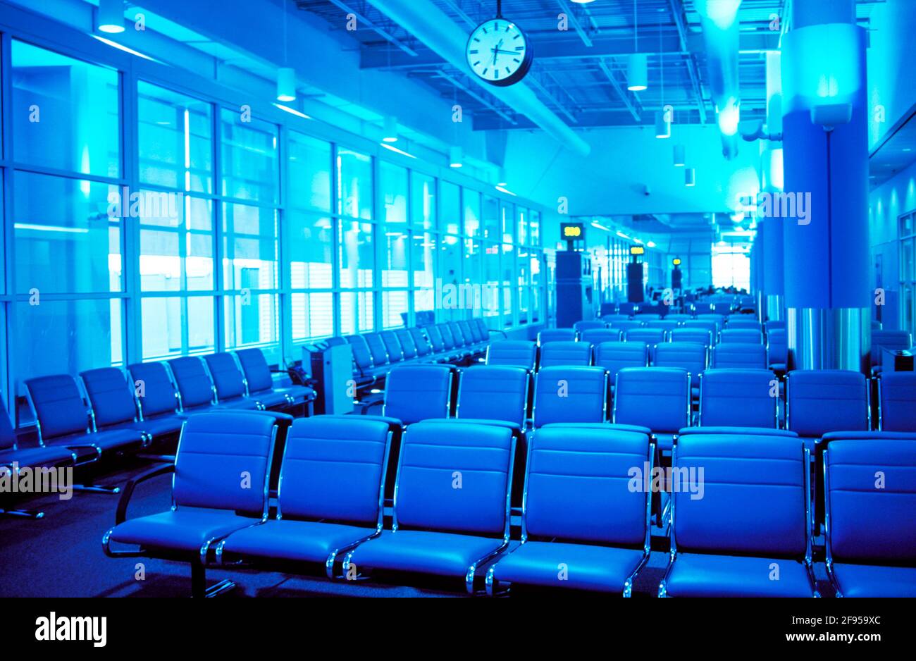 Canada, Ontario, Toronto. Pearson International Airport. Airport lounge with empty seats and clock. Stock Photo