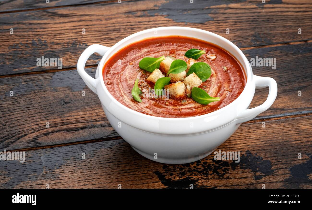 Bowl of tomato soup on wooden table with copy space Stock Photo