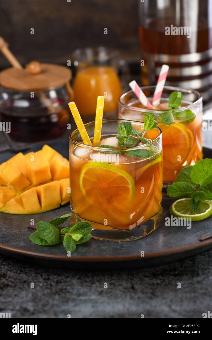 Mango iced tea with lime and mint. Refreshing organic soft drink Stock Photo