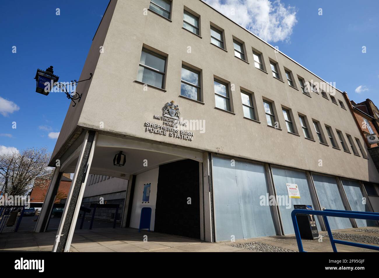 London, UK - 15 Apr 2021: Shepherds Bush police station. Front counter services for the public were recently closed and as a result the ground floor has been boarded-up. Stock Photo