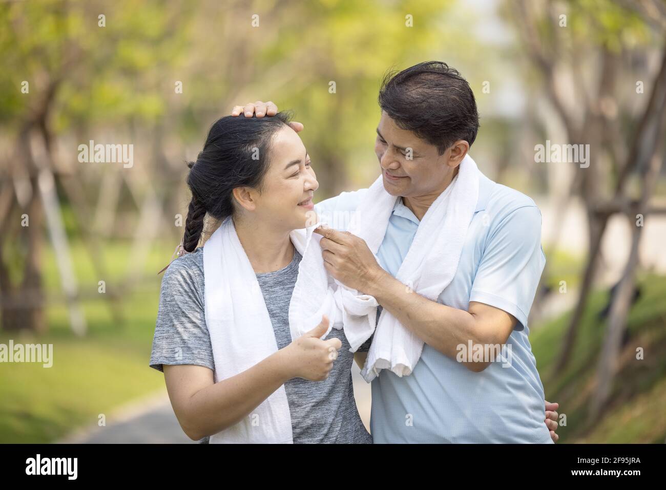 Happy asia senior couple jogging outdoors in park Stock Photo - Alamy