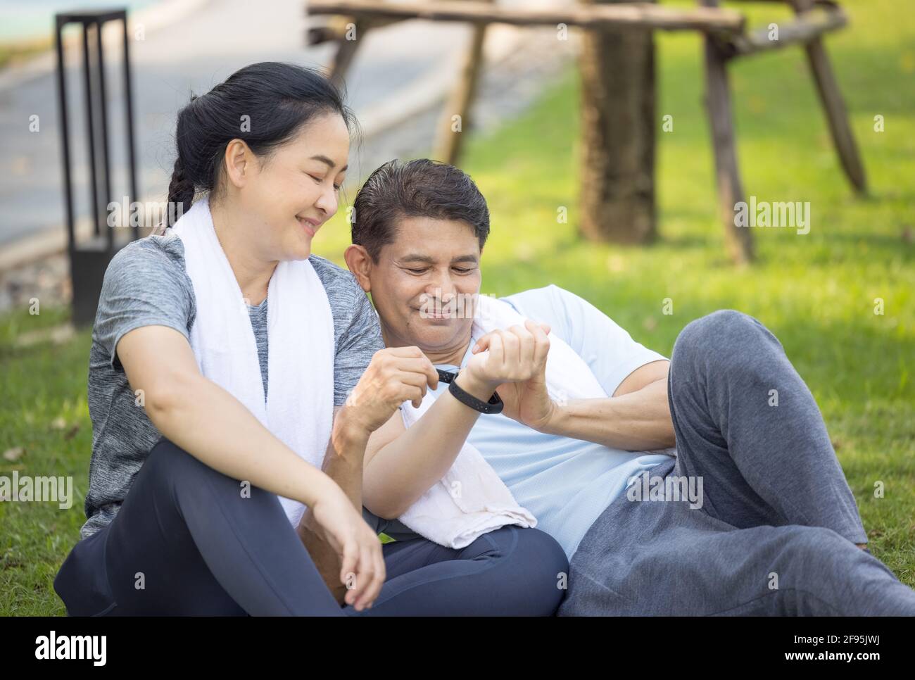 Couple doing stretching exercise after jogging Stock Photo