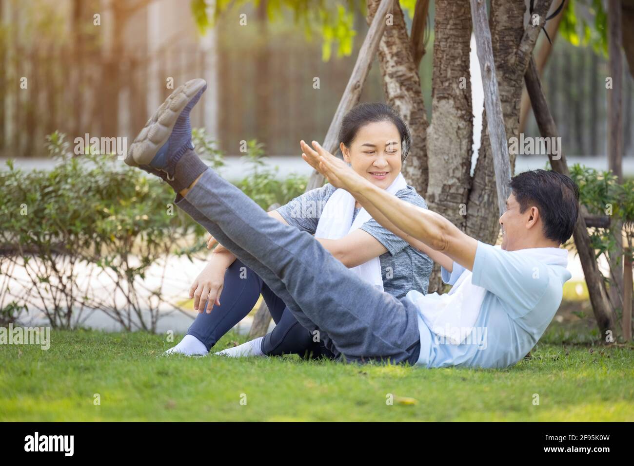 Couple doing stretching exercise after jogging Stock Photo