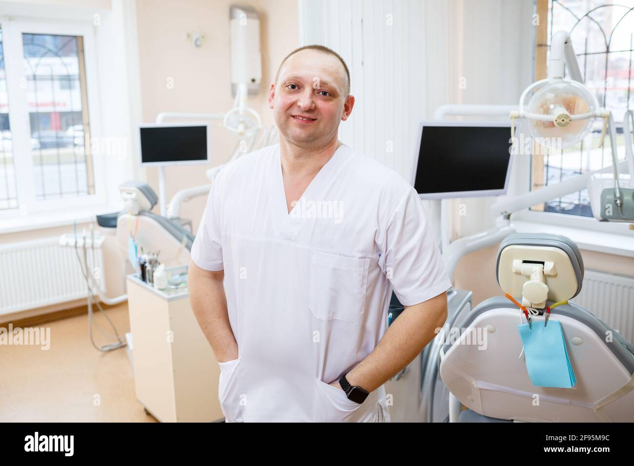 Docor Robe Man Portrait of smiling man in white doctor robe uniform is standing in ...