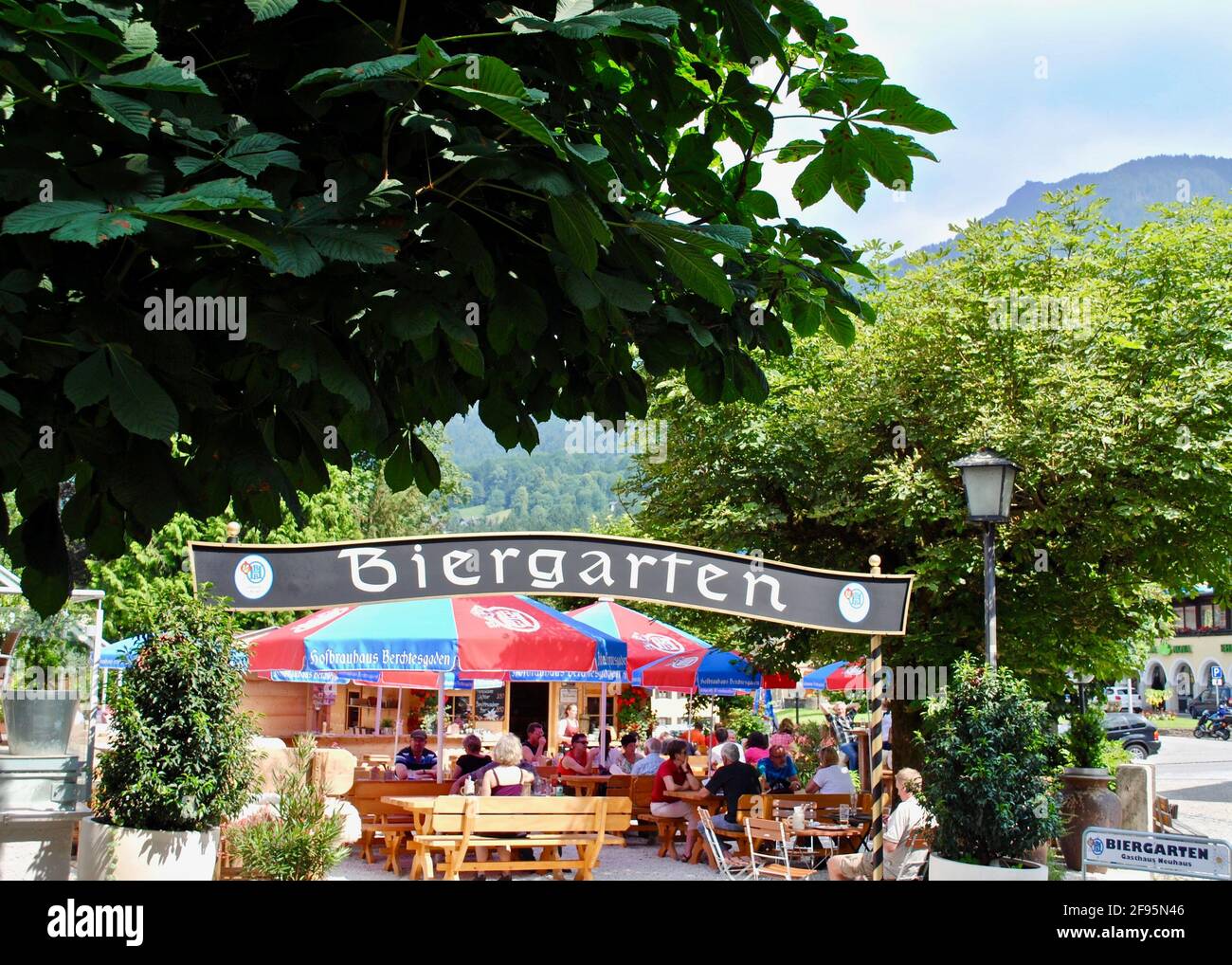 Berchtesgaden, Germany: A traditional German Biergarten (Beer Garden) in Bavaria. Umbrellas read 'Hofbrauhaus Berchtesgaden' (Berchtesgaden Brewery) Stock Photo