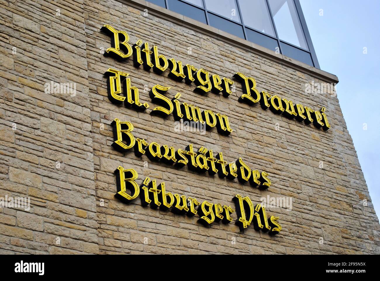Bitburg, Germany: Bitburger Brewery (Bitburger Brauerei) exterior. Signage reads 'Bitburger Brewery Th. Simon Company Brewing Bitbuger Pils' Stock Photo