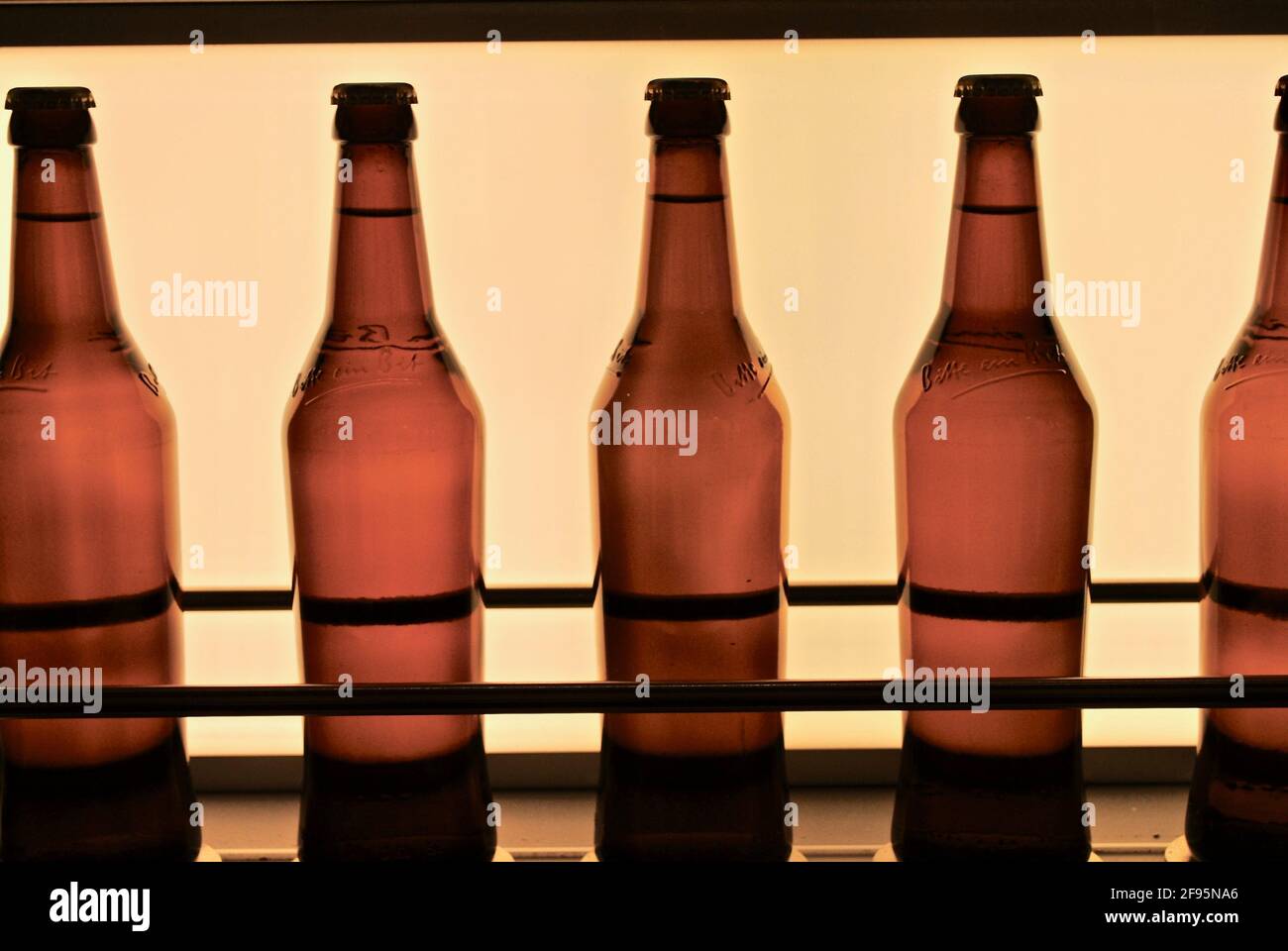 Bitburg, Germany: Bitburger beer bottles on a conveyer belt. Bitburger Brewery (Bitburger Brauerei) is a large German brewery founded in 1817. Stock Photo