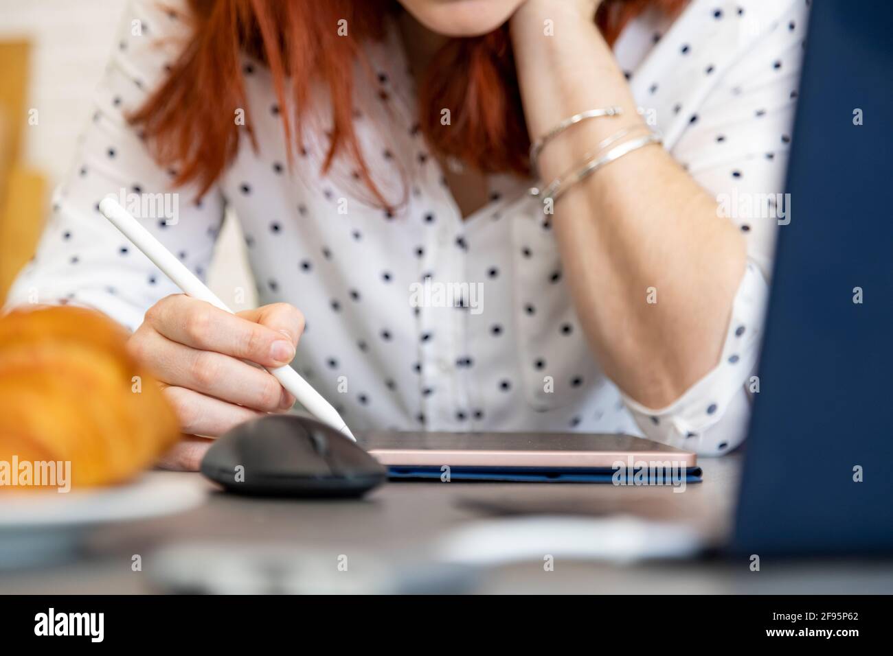 woman draws on a digital tablet with a touch screen. no face. close-up. Stock Photo