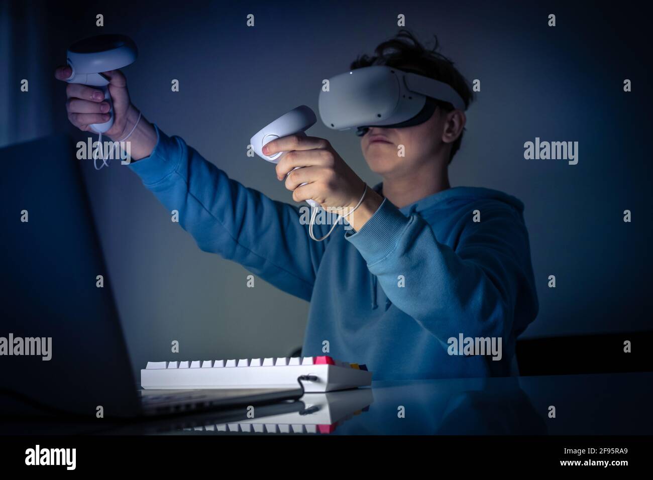 Teenager playing with virtual reality device. Cyberpunk futuristic mood,  immersive experience with video game and VR 3D viewer technology. People  usin Stock Photo - Alamy