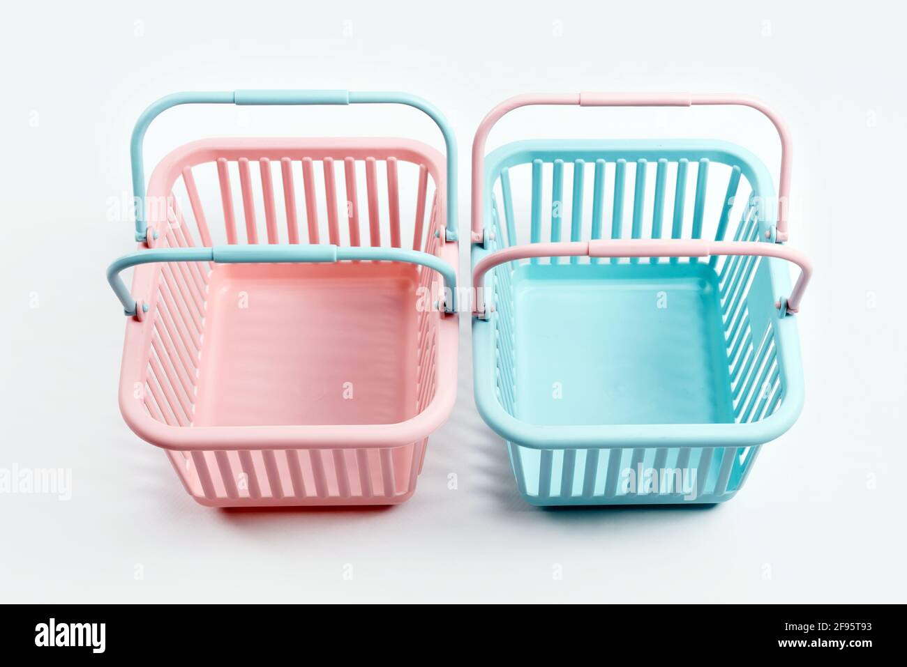 Colorful plastic shopping baskets. Empty pink and blue supermarket ...