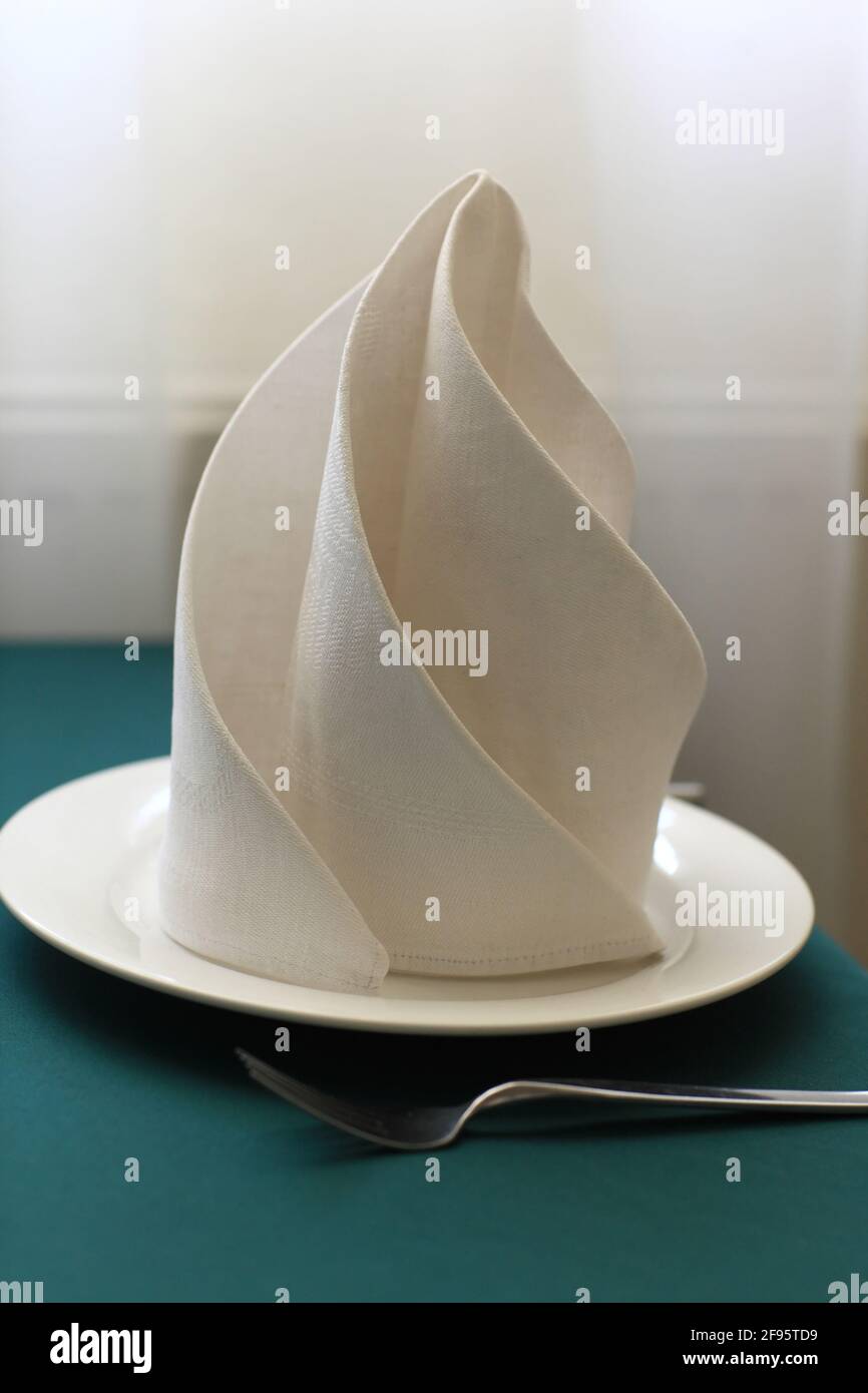 Served empty plate with napkin in a restaurant Stock Photo