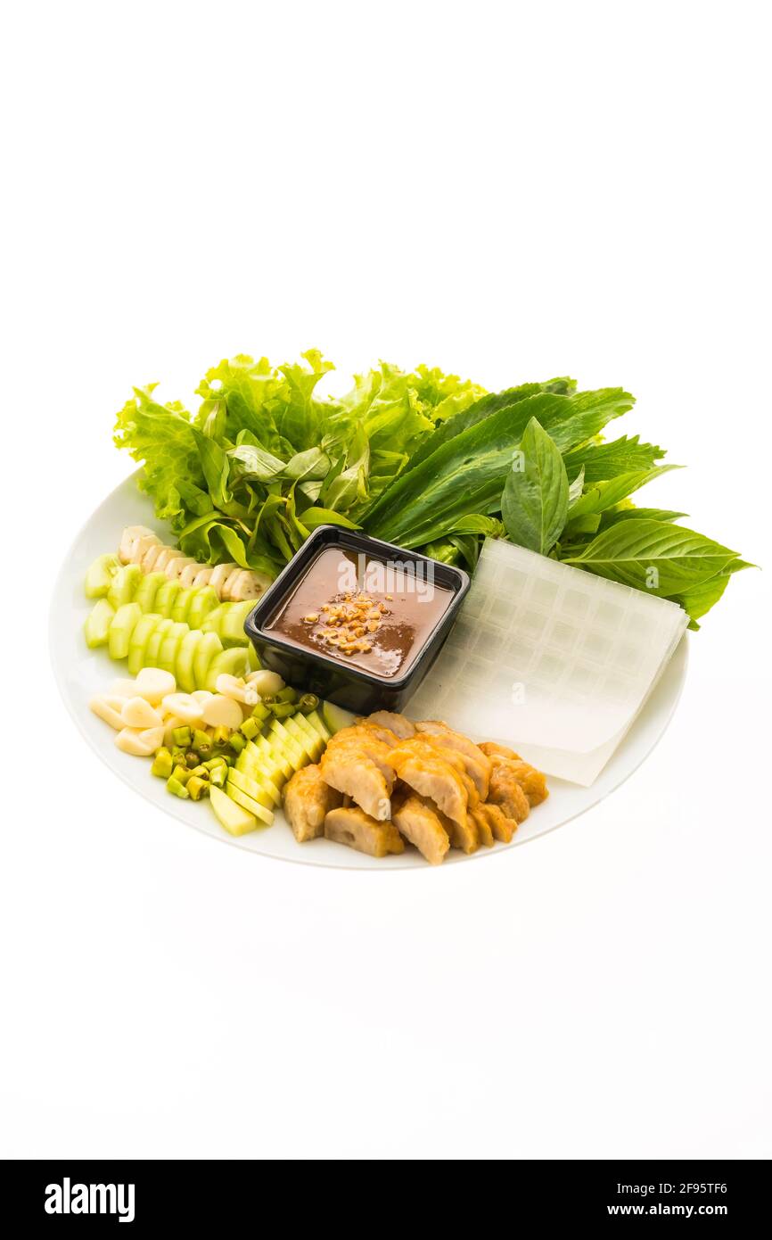 Vietnamese Pork Sausage and salad OR Nam-Neaung in white plate isolated on white background Stock Photo