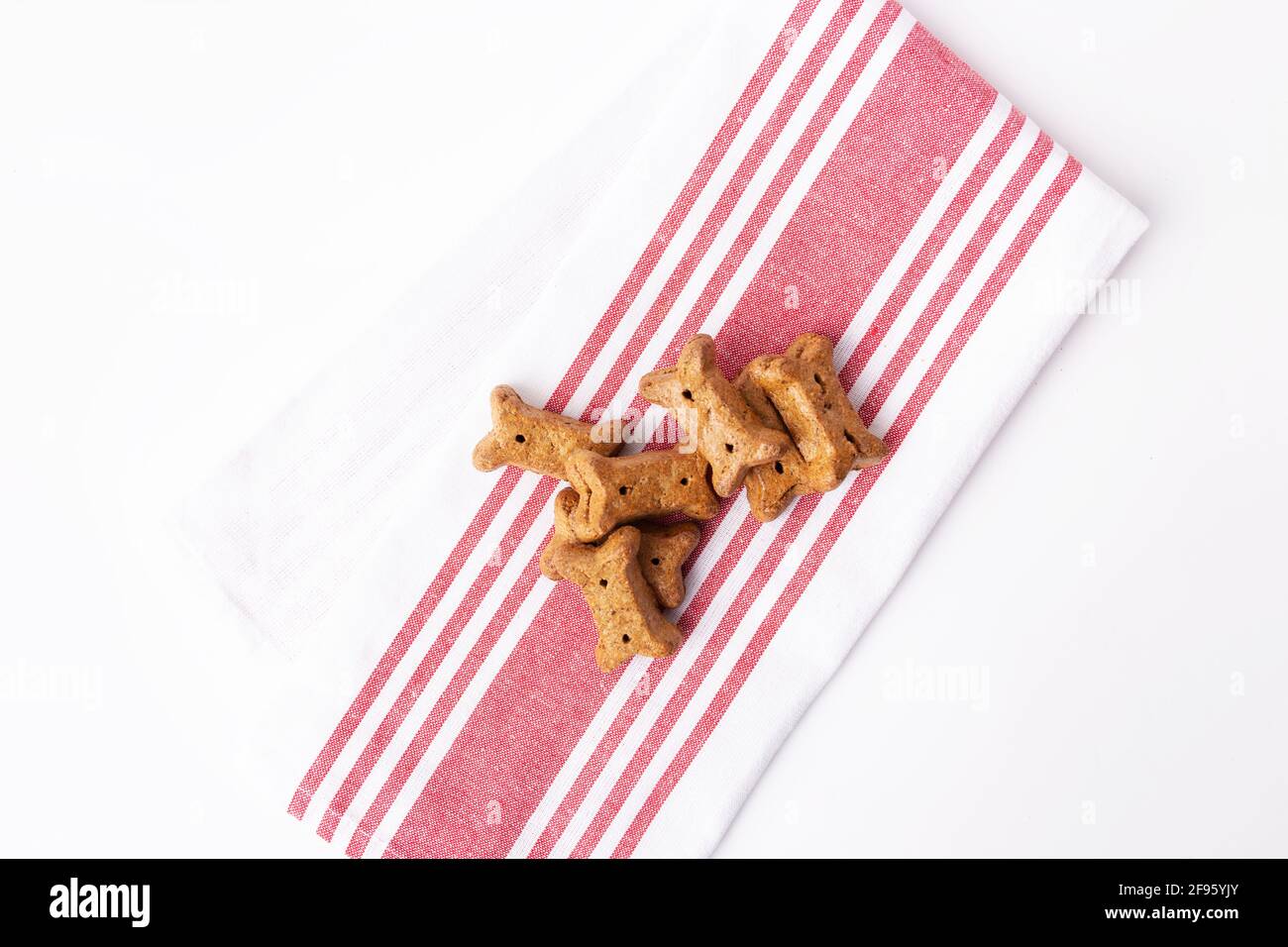 Top view of pile of brown dog biscuits on red and white kitchen towel Stock Photo