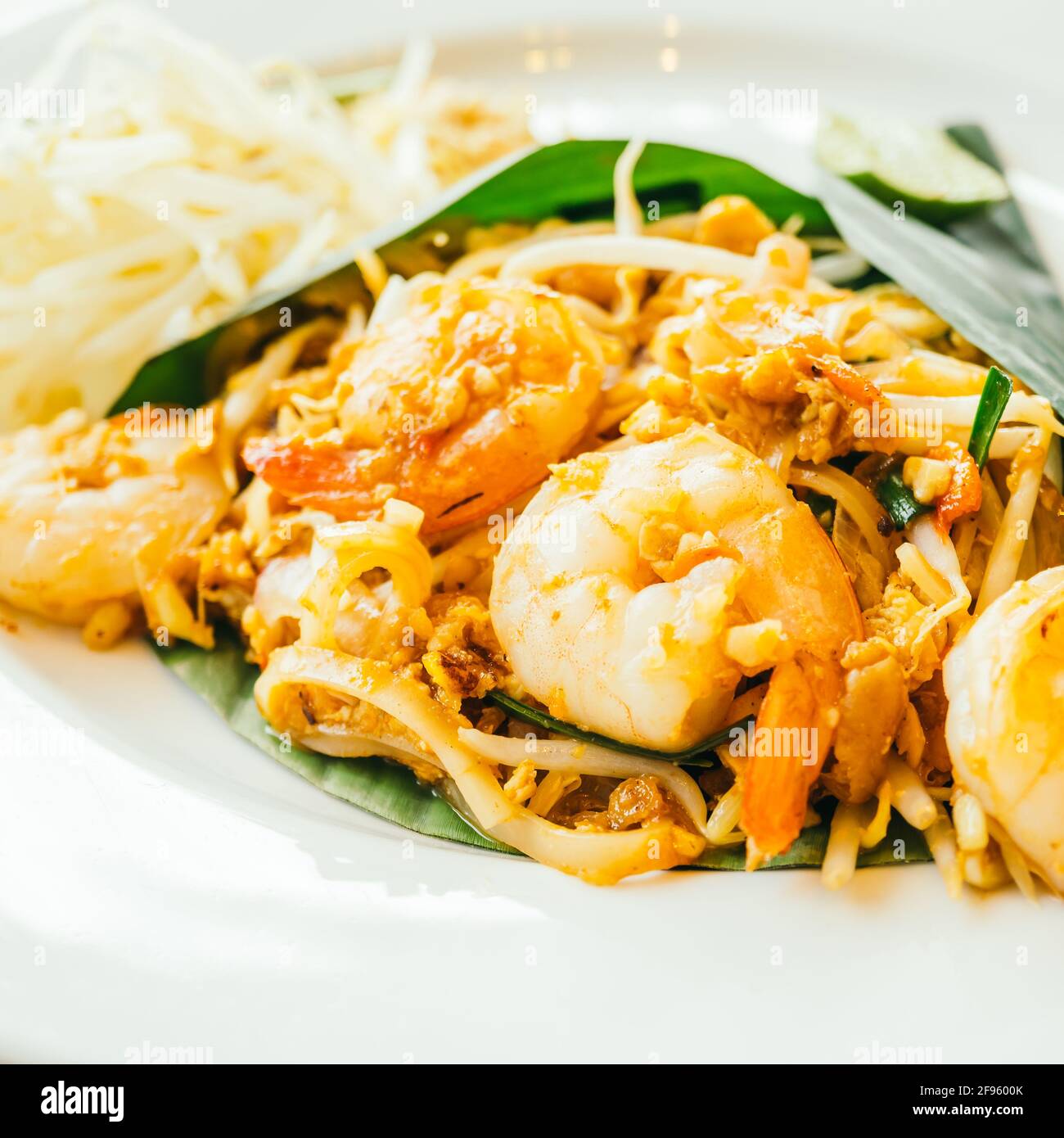 Pad thai noodles with prawn in white plate - Color Filter Processing Stock Photo