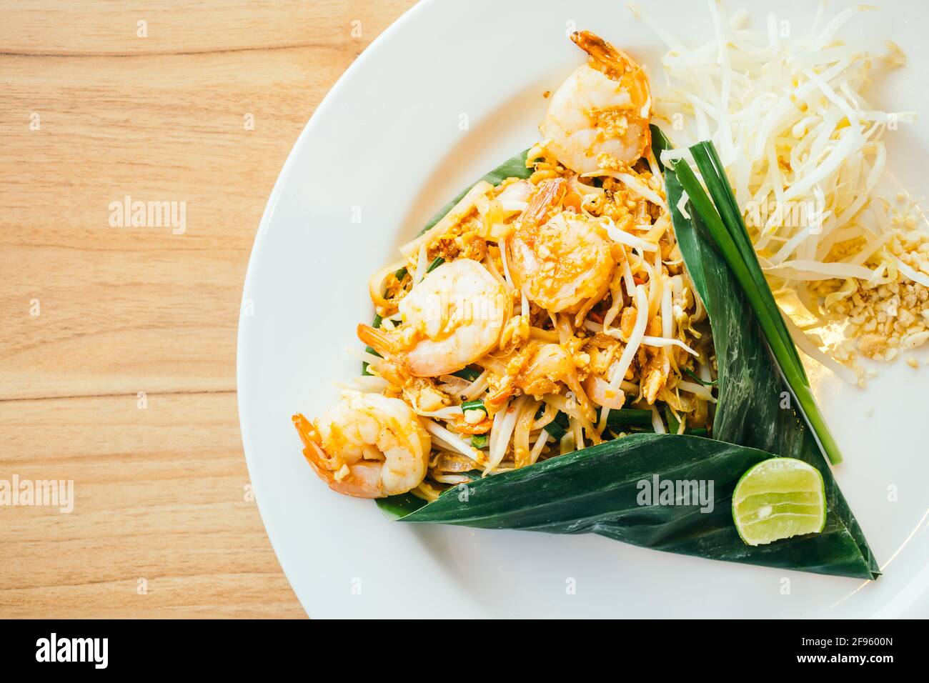 Pad thai noodles with prawn in white plate - Color Filter Processing Stock Photo