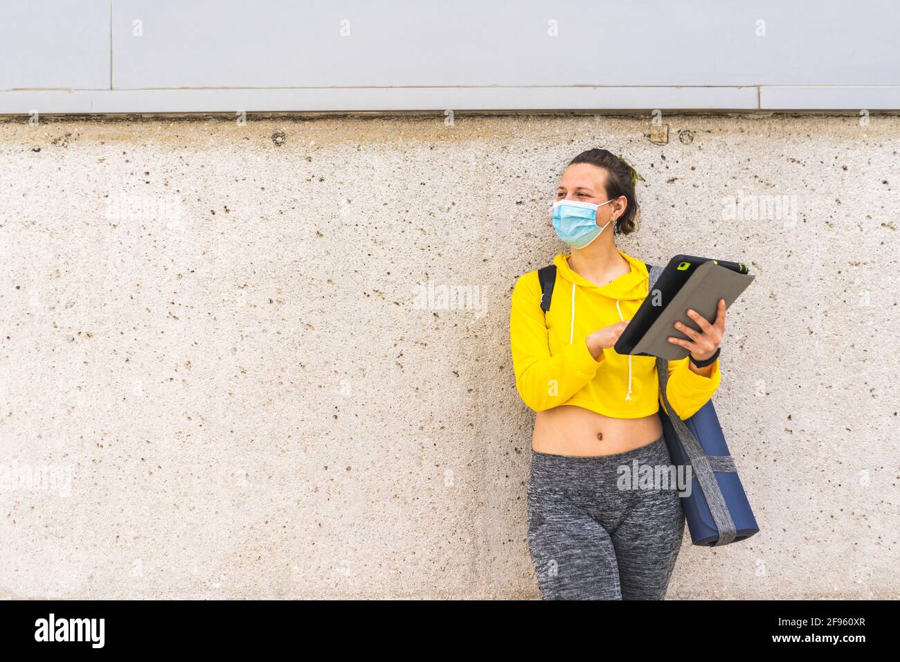 Active woman with tablet sportswear and mask using tablet Stock Photo