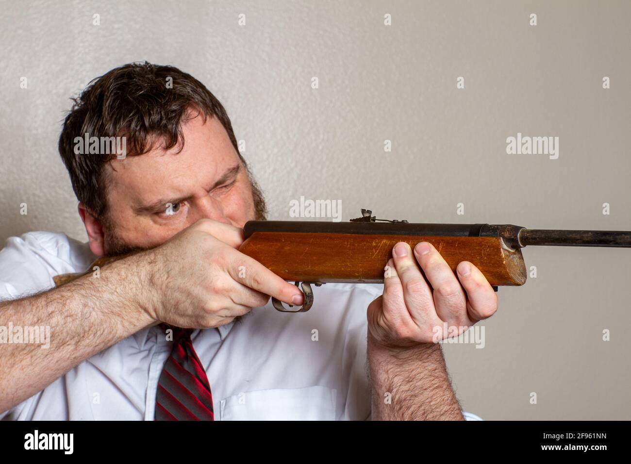 man pointing a gun while at work Stock Photo