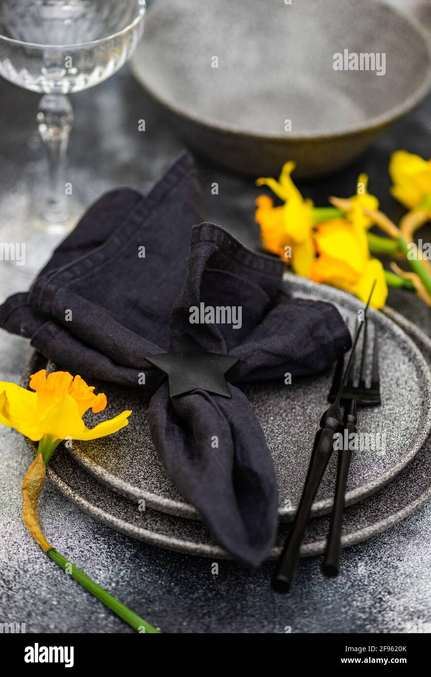 Spring table setting with daffodils Stock Photo