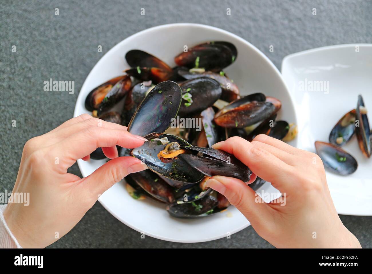 Closeup Hands Grabbing Mussel's Meat Out by Using an Empty Mussel Shell
