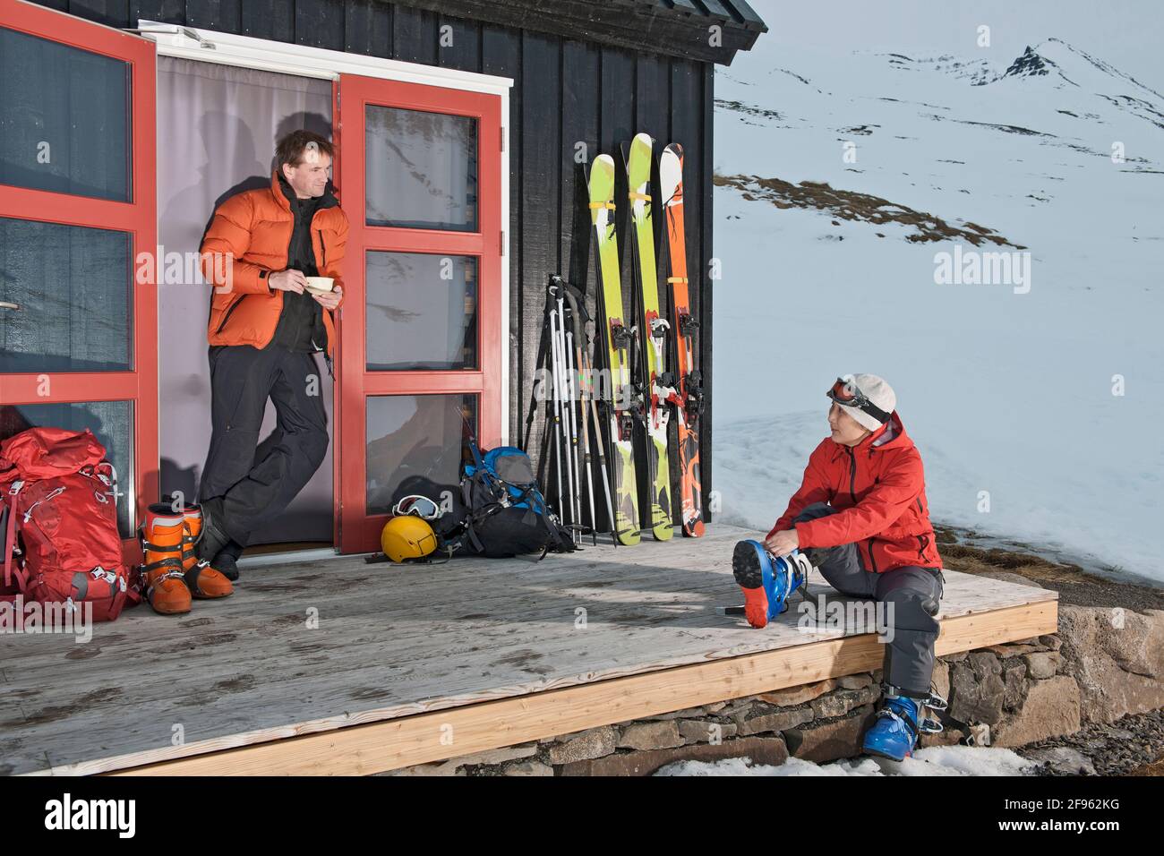 couple getting ready for ski touring at ski cottage in Iceland Stock Photo