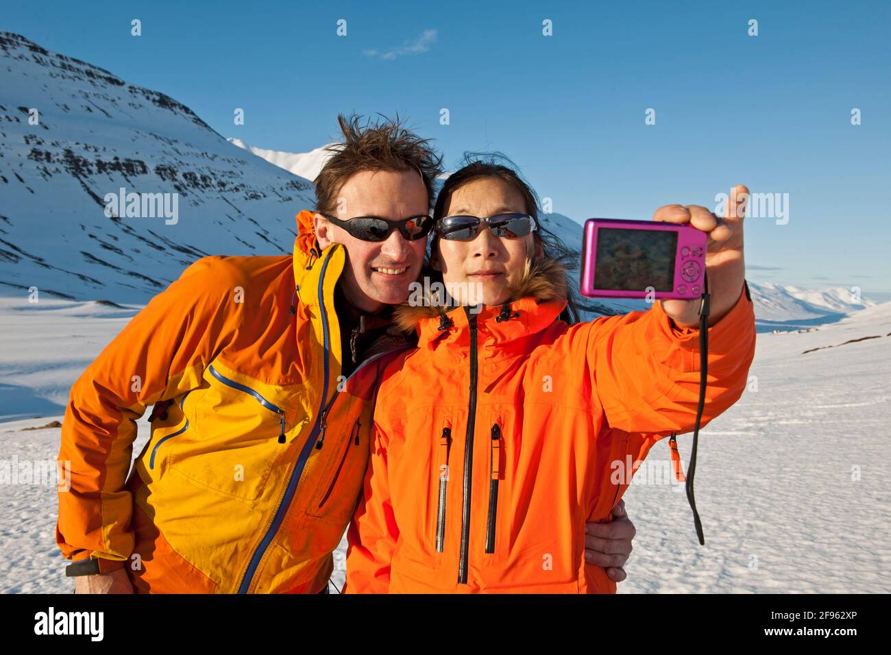 couple taking selfie with compact camera in Iceland Stock Photo