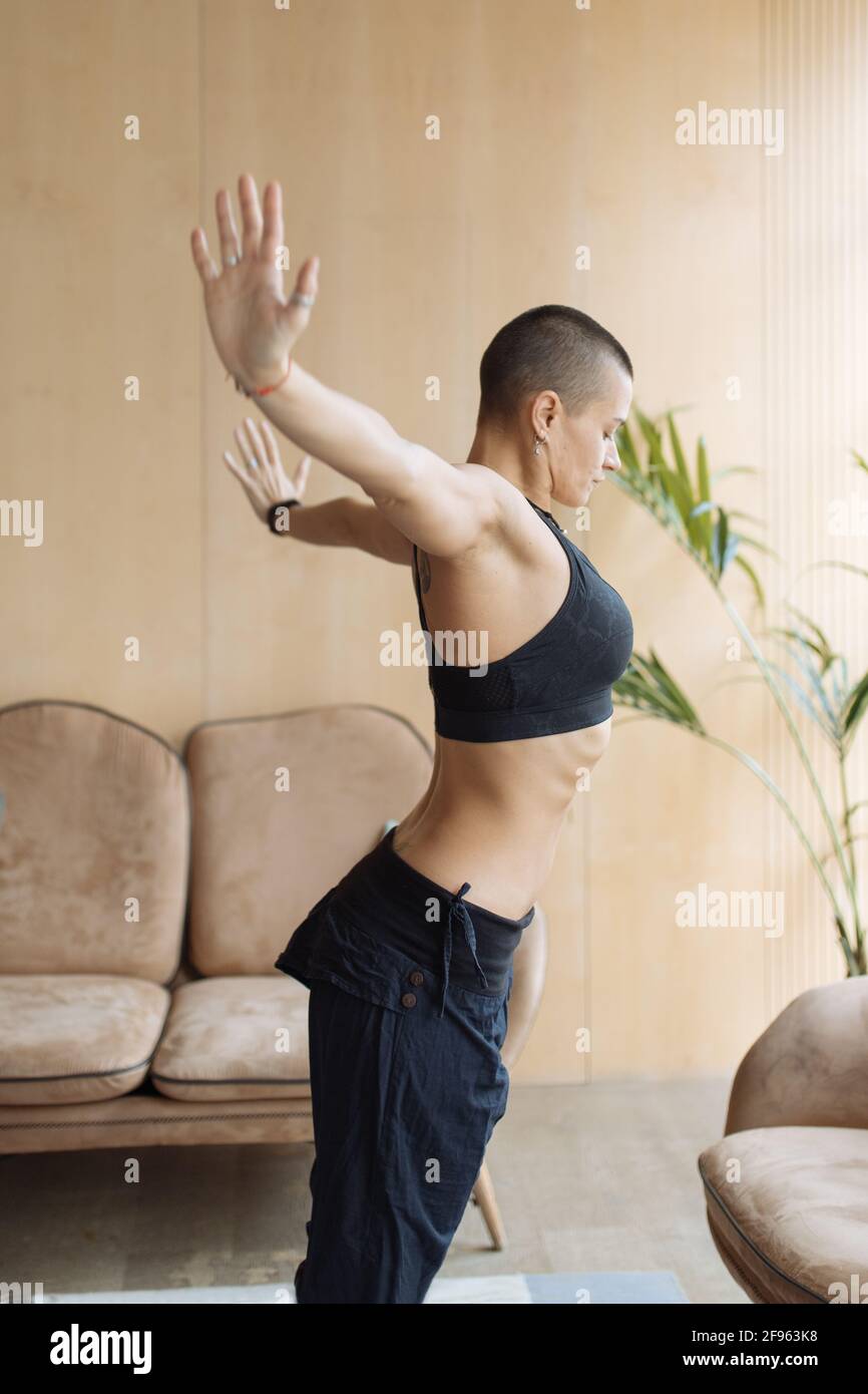 fit woman doing yoga exercise at home interior Stock Photo