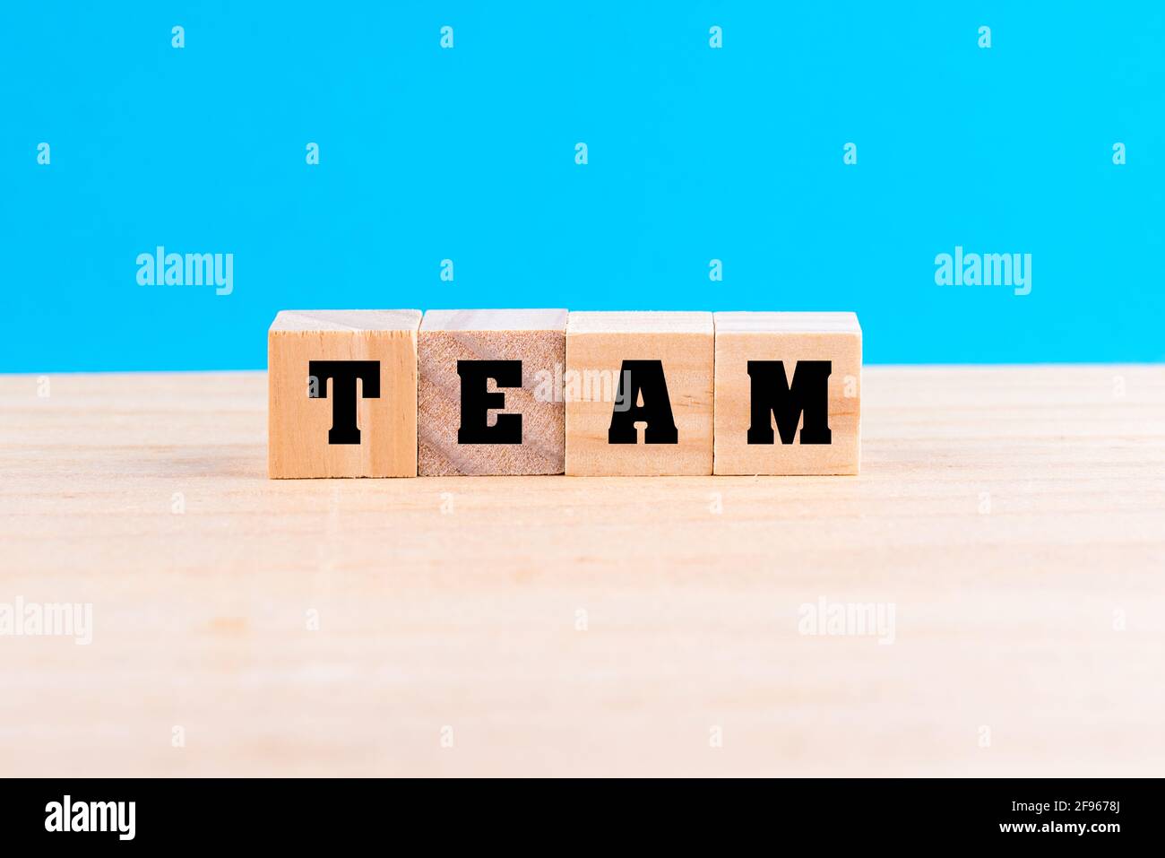 Word TEAM formed with wooden blocks in blue background - the concept of ...