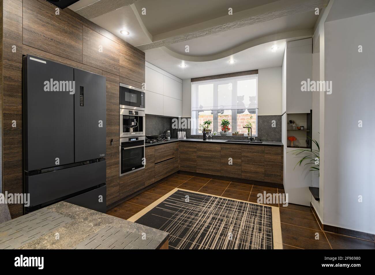 Modern luxurious dark brown, gray and black kitchen details Stock Photo