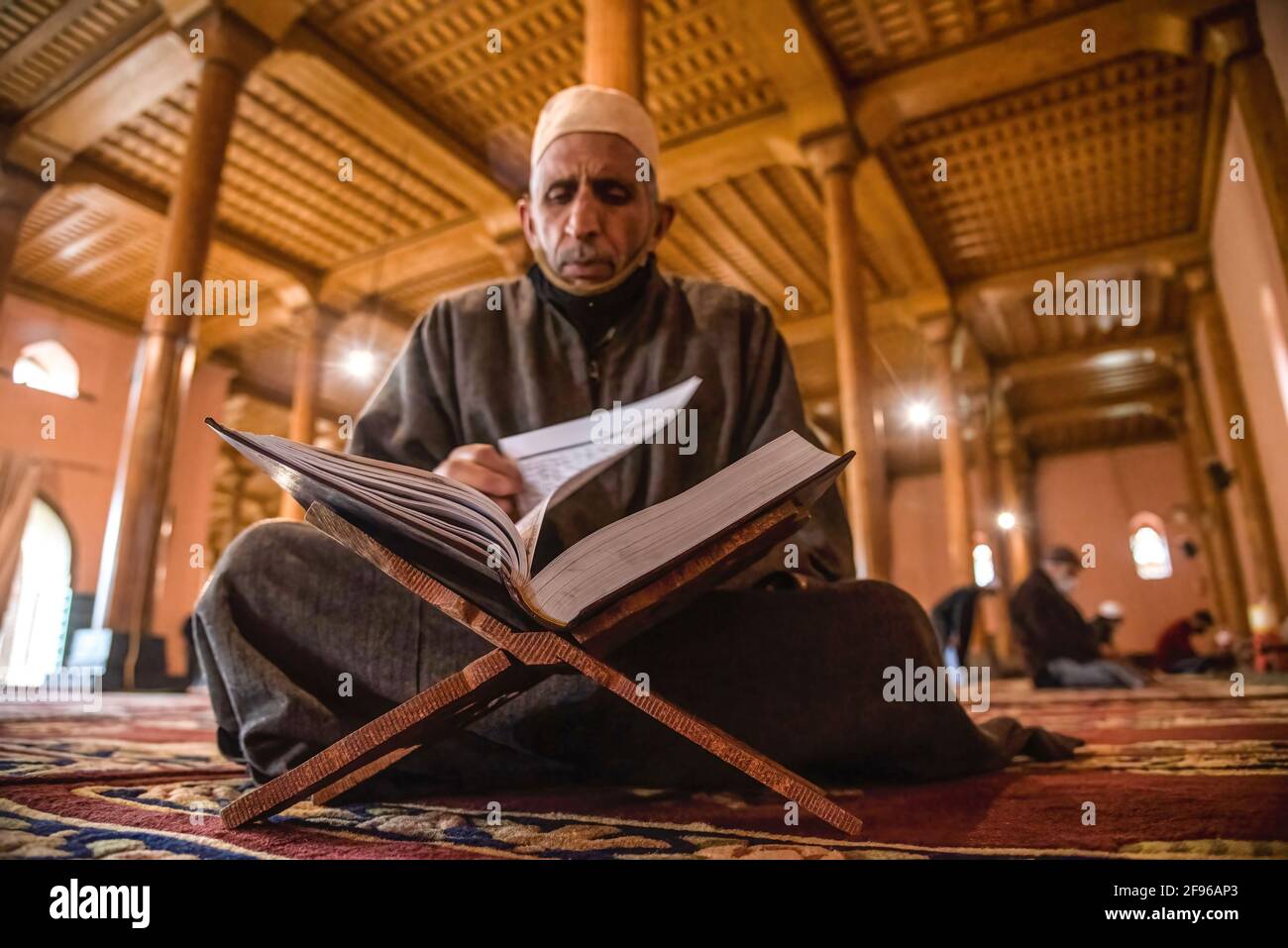 A Kashmiri Muslim reads a Holy Book of Quran on first Friday of ramadan ...