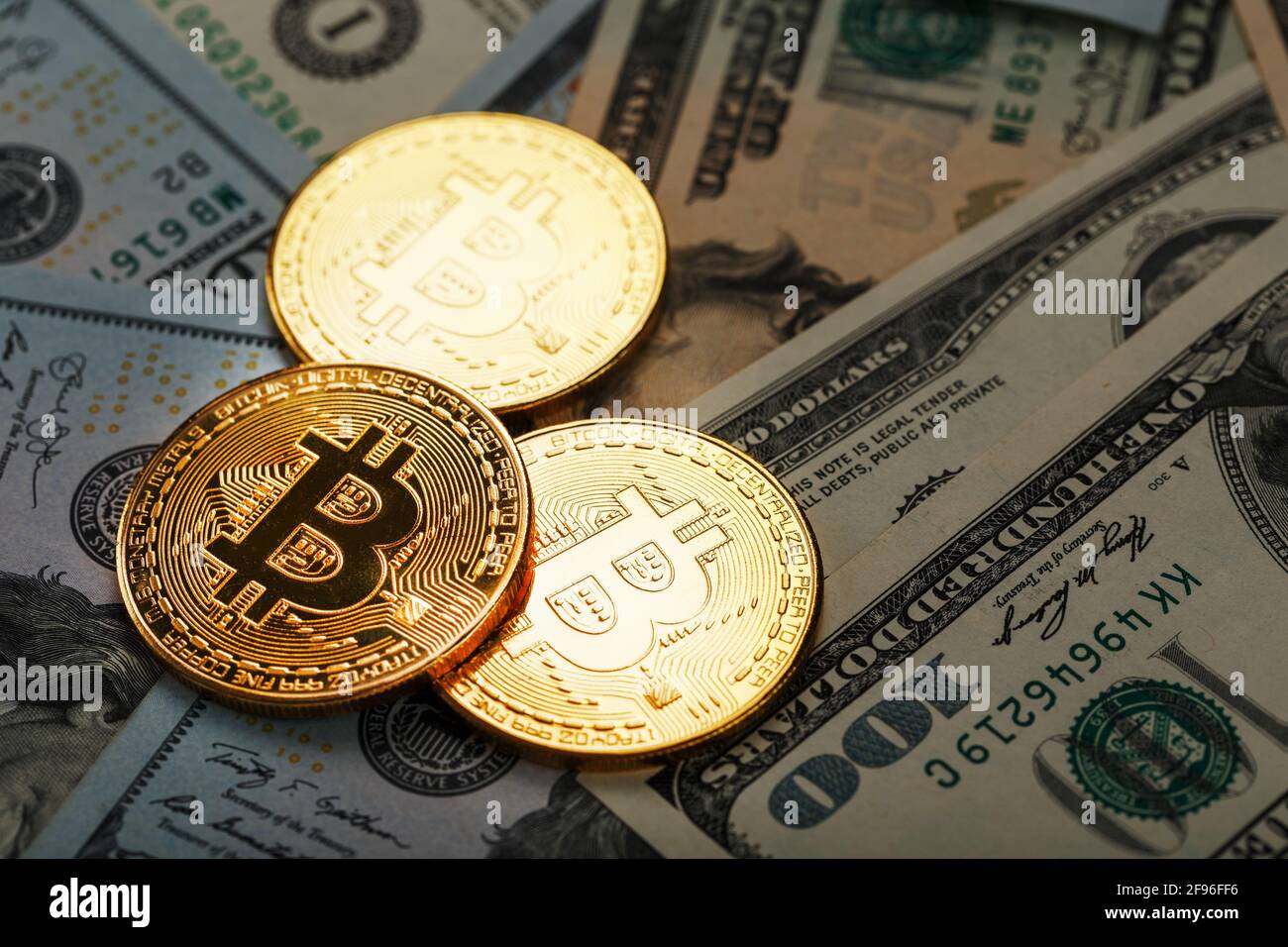 over dollar banknotes. CrypGold bitcoin coins on the background of dollar  bills with the concept of the exchange rate of the financial markets.  Bitcoi Stock Photo - Alamy