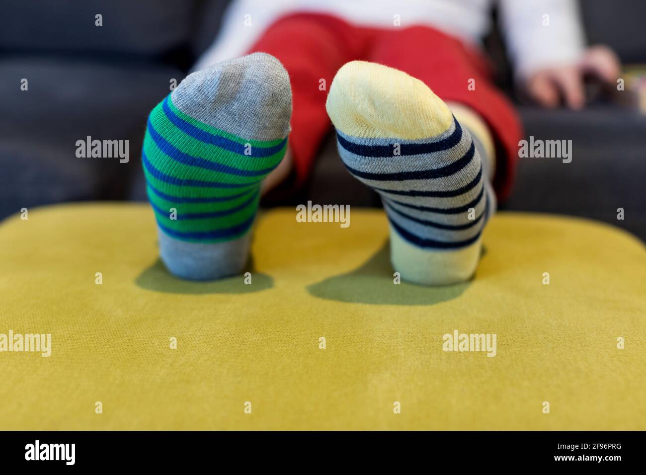 Down syndrome awareness concept. Boy wearing different socks while