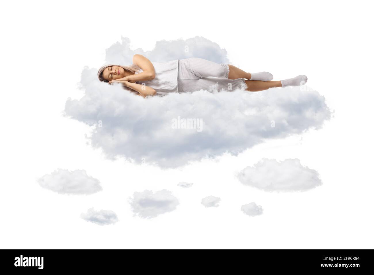 Young woman in pajamas sleeping on clouds isolated on white background