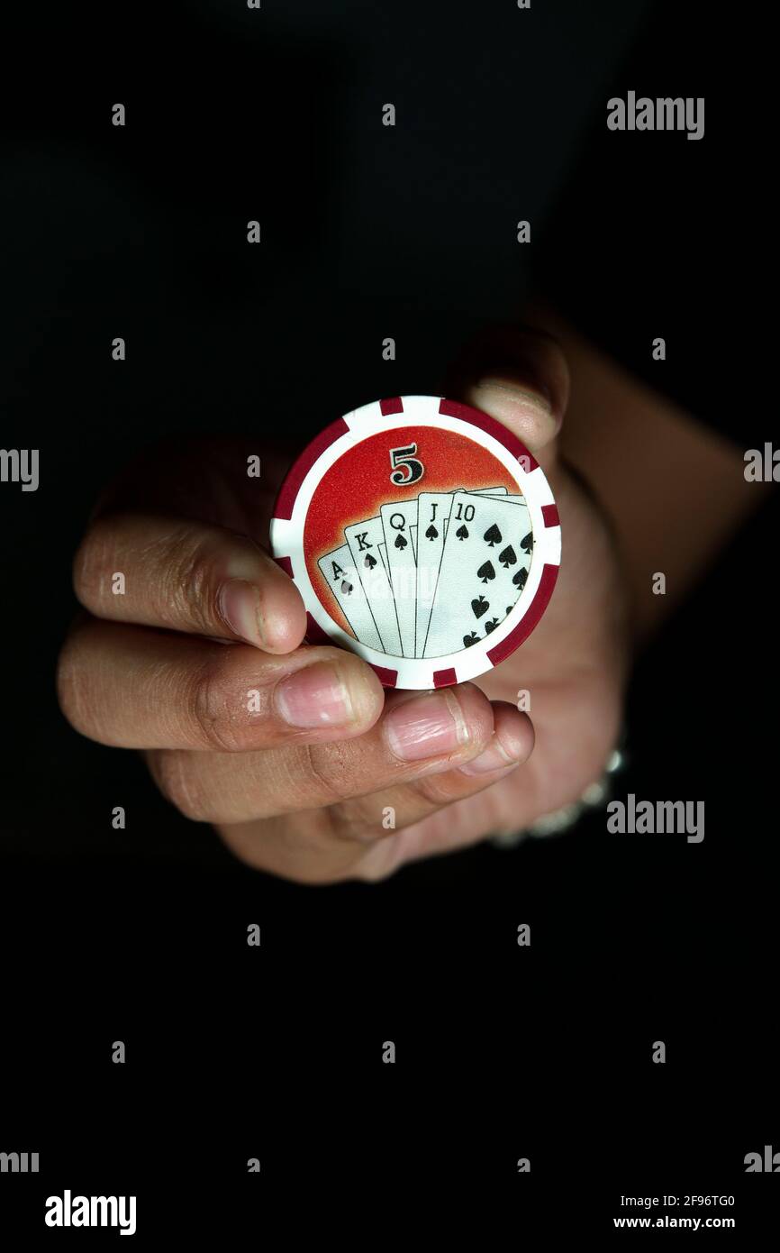 five value chip hand hold gambling play Stock Photo