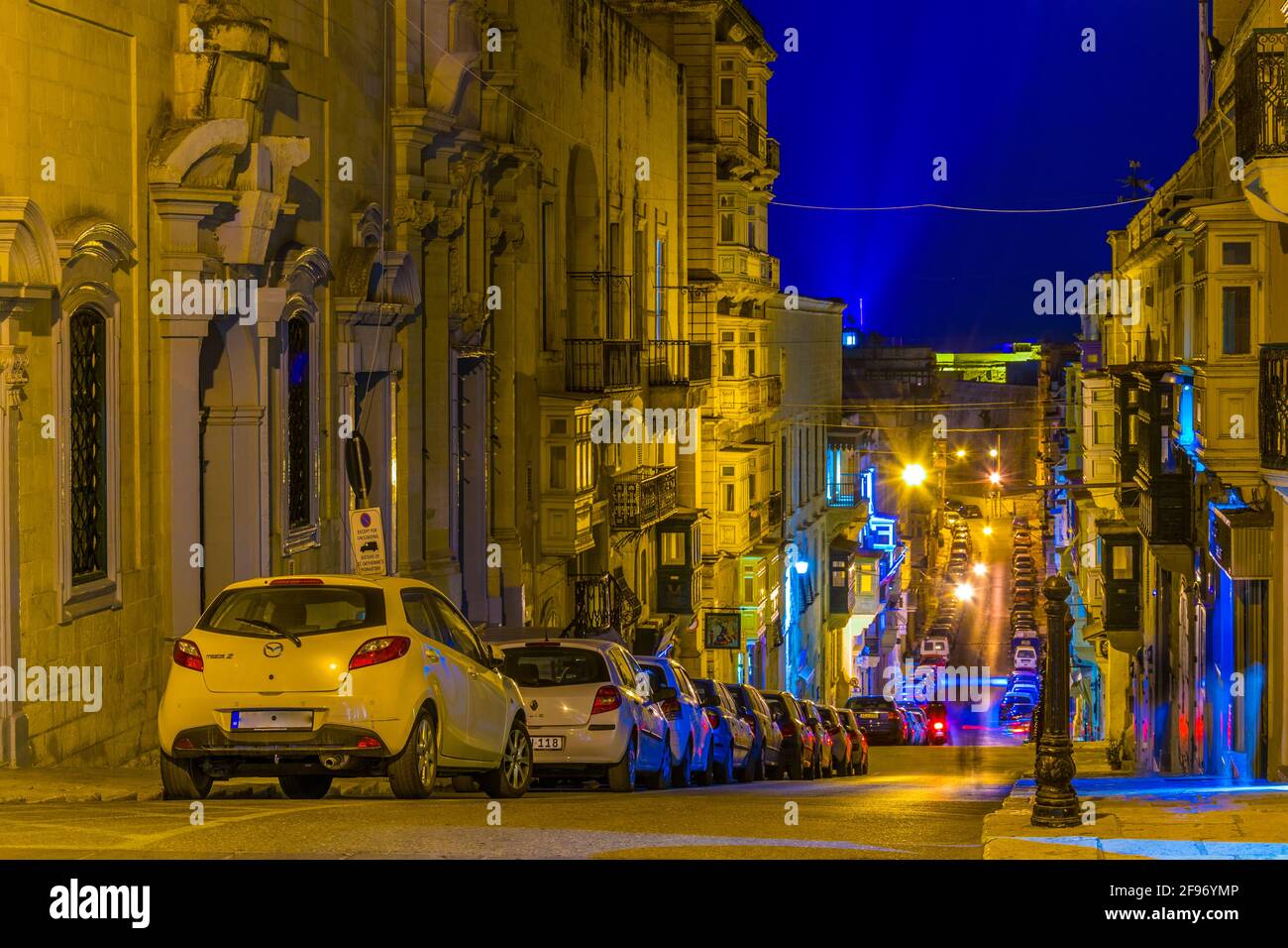 Night view of a narrow street in Valletta, Malta Stock Photo