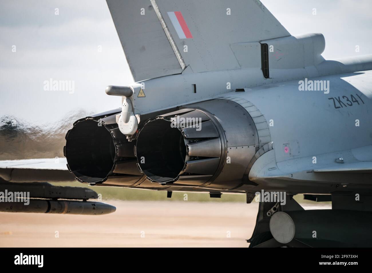 Modern Typhoon Eurofighter military combat jet fighters aircraft stationary on runway with engine running heat blur from ef2000 aircraft afterburner Stock Photo