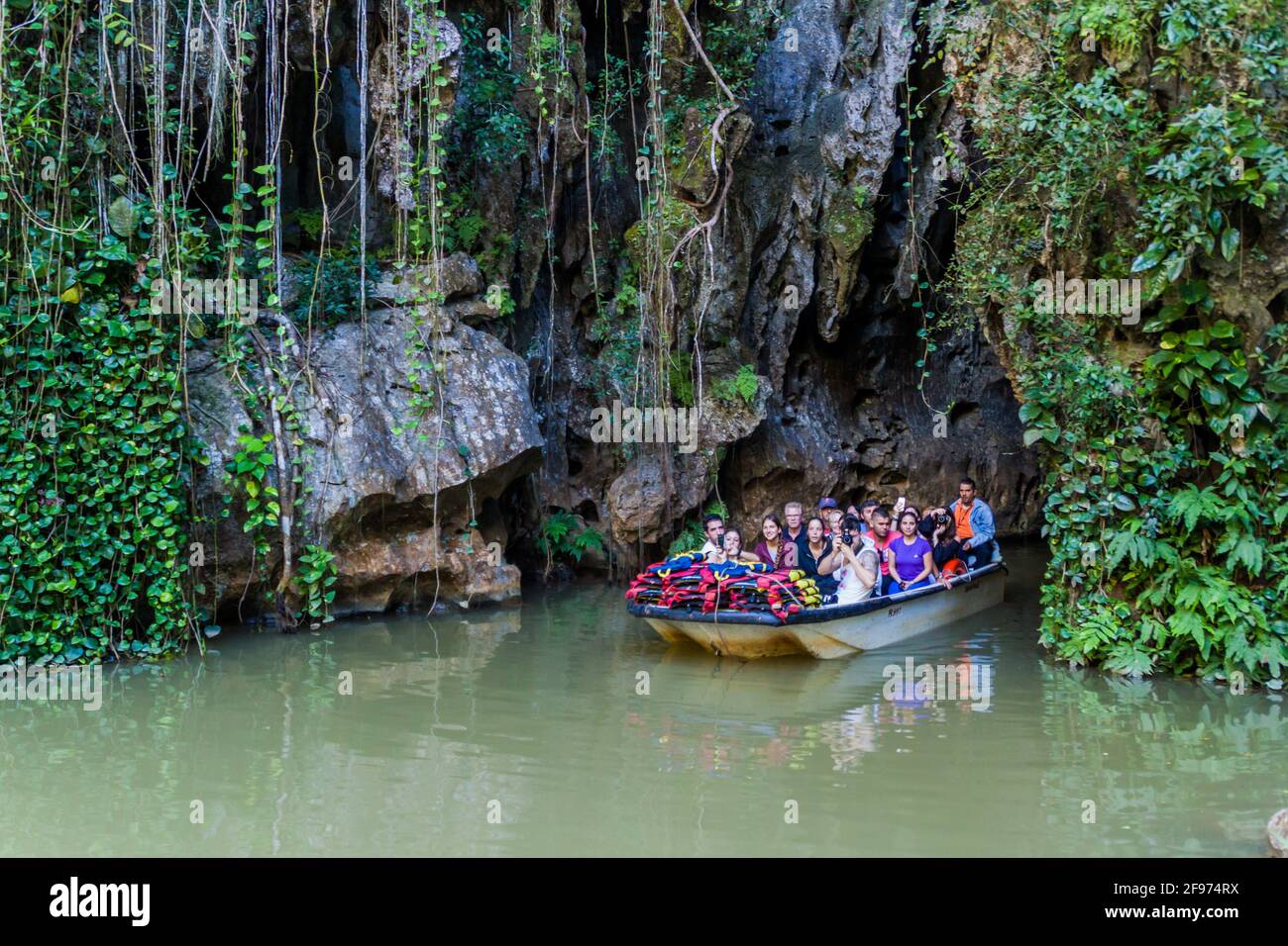 VINALES, CUBA - FEB 18, 2016: Tourists in a boat are leaving Cueva del Indio cave in National Park Vinales, Cuba Stock Photo