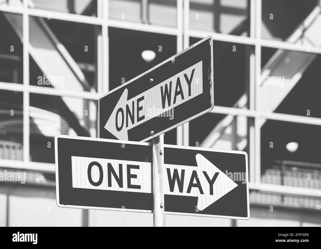 Black and white picture of One Way road signs in New York City, selective focus, USA. Stock Photo