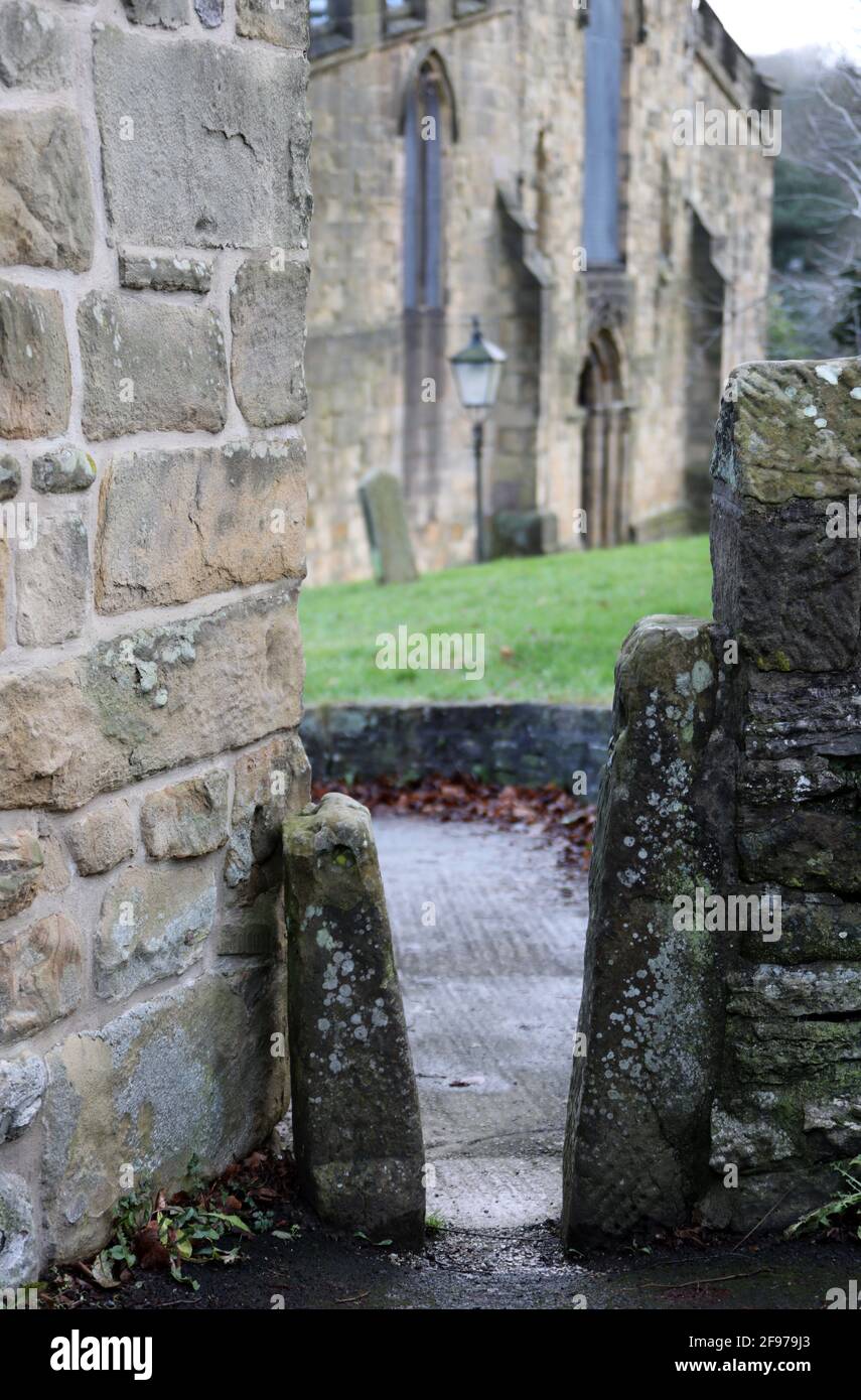 Stone squeeze stile into the churchyard of All Saints Church in Bakewell Stock Photo