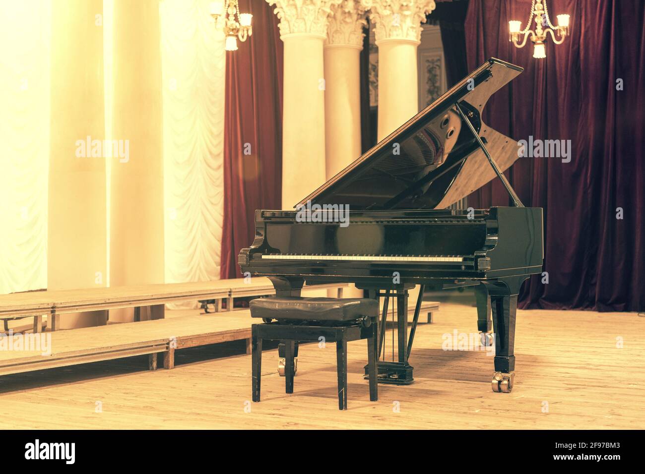 Grand Piano in Concert Hall. Piano standing on empty stage. opened
