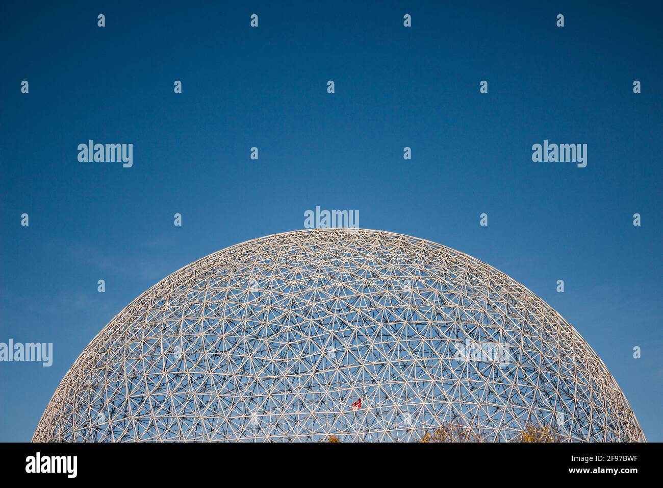 The dome of the Biosphere against the blue sky of early fall. Taken at Montreal's Jean-Drapeau Park. The museum is dedicated to the environment, it wa Stock Photo