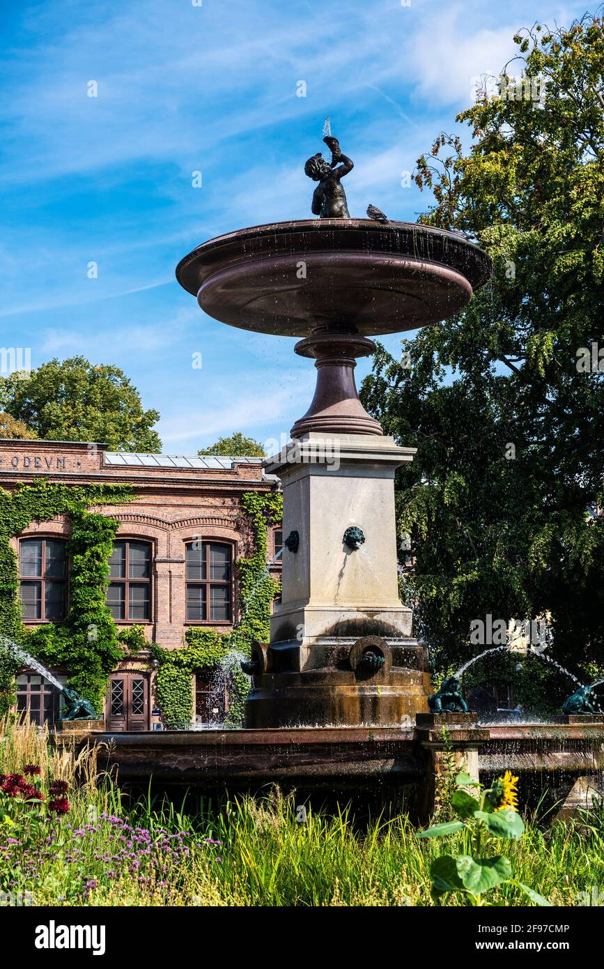 Fountain and the classic facade of a buiding of the Lund University in