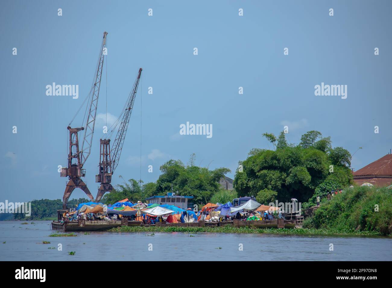 DRC: Bumba's broken cranes, meant to help load the thousands of tons of cargo sent to Kinshasa, which instead is loaded manually bag by bag. Stock Photo