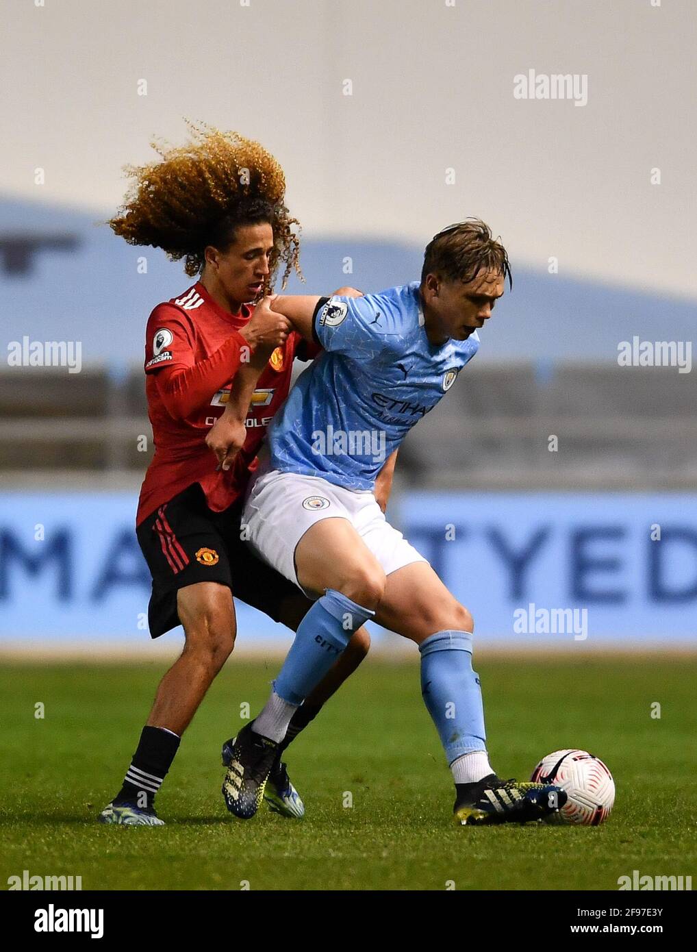 Manchester, UK. 16th Apr, 2021. Callum Doyle (4 Manchester City) battles for the ball with Hannibal Mejbri (10 Manchester United) during the Premier League 2 match between Manchester City and Manchester United at the Academy Stadium in Manchester, England. Credit: SPP Sport Press Photo. /Alamy Live News Stock Photo