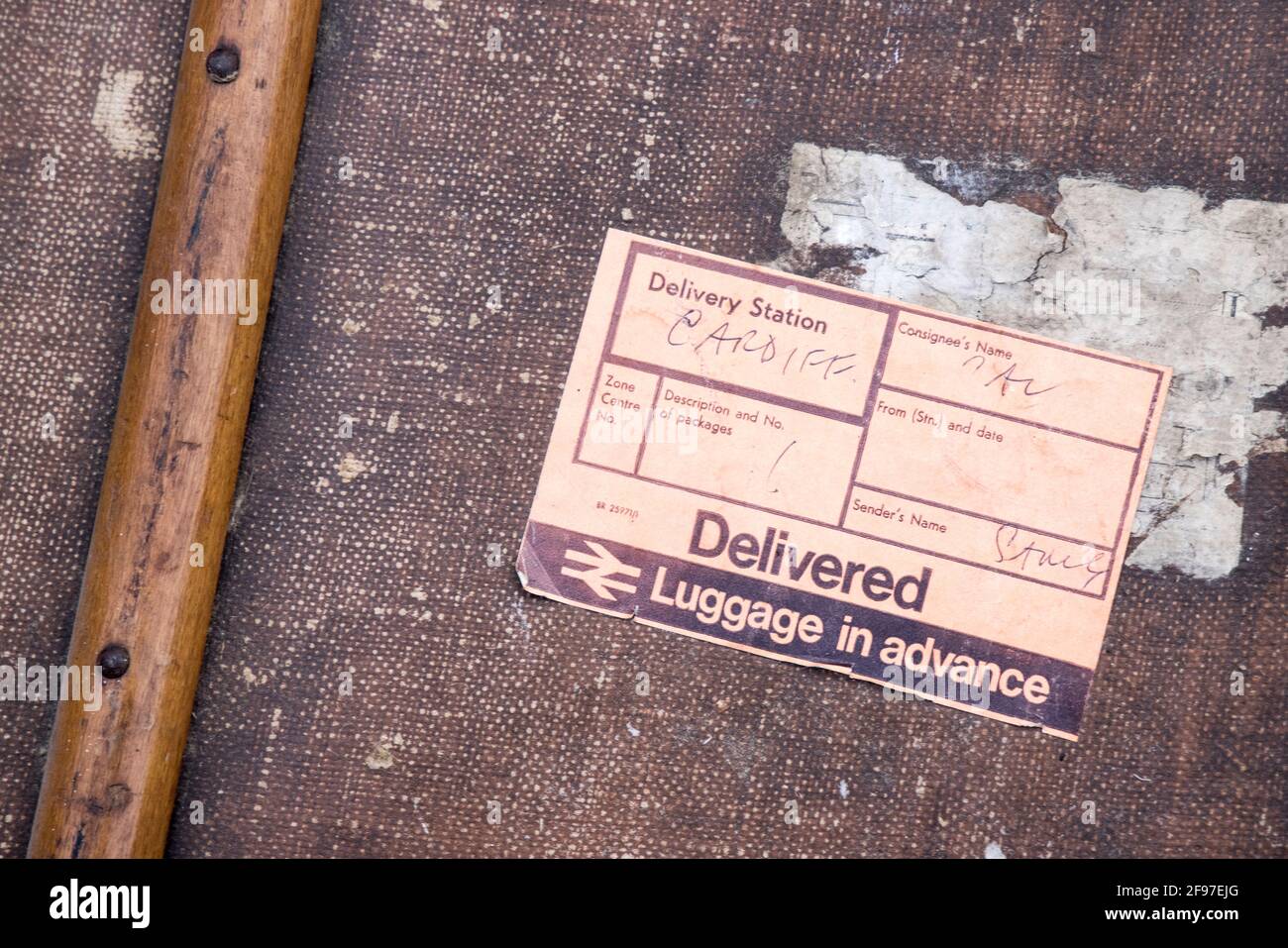 Luggage in advance sticker on classic luggage trunk that has been used for rail delivery, 1970s, UK Stock Photo
