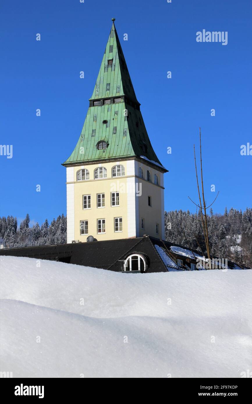 Tower of Schloss Elmau Luxury Spa Retreat & Cultural Hideaway in the Elmauer Valley between Garmisch-Partenkirchen and Mittenwald was the venue for the political G7 summit in June 2015 with the presidents and prime ministers of the world's most important nations. Winter in Werdenfelser Land, Europe, Germany, Upper Bavaria Bavaria, Krün near Mittenwald, dream weather, snow area in the foreground Stock Photo
